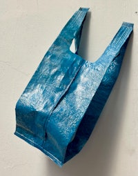 a blue shopping bag hanging on a wall